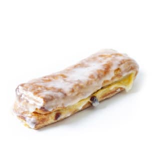 Ein rechteckiges Gebäck mit einer goldgelben Blätterteigkruste, die mit einer glatten weißen Glasur überzogen ist und im Inneren eine sichtbare Schicht cremiger Füllung aufweist. Das Gebäck ist auf einem schlichten weißen Hintergrund abgebildet.