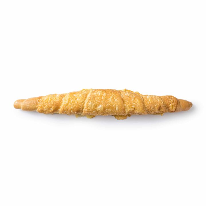 Ein langes, goldbraunes Croissant mit einer knusprigen, flockigen Textur, bestreut mit Sesam, von oben gesehen auf weißem Hintergrund.