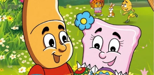 Zwei lächelnde Zeichentrickfiguren, eine Scheibe Brot und ein Stück rosa Toast, halten verzierte Ostereier auf einer blumenreichen Wiese. Im Hintergrund spielen ein Hase, eine Katze und eine weitere Zeichentrickfigur im Gras.