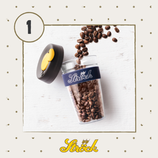 A glass cup filled with coffee beans, a black lid with a yellow accent resting beside it, and a blue Stöck-branded sleeve, on a white background with small decorative dots and the number 1 in the corner.
