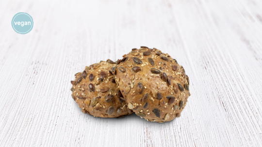 Zwei Brötchen mit Körnern und einem runden veganen Etikett in der oberen linken Ecke.